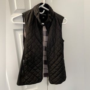 Like new, extremely comfortable black vest with plaid inner lining, size XS